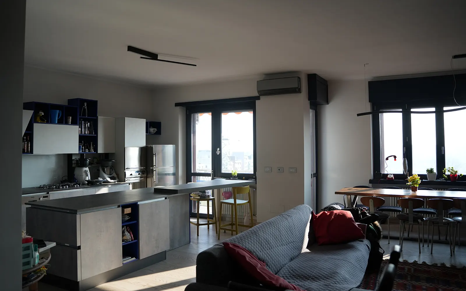 Vista generale open space con cucina e soggiorno in appartamento ristrutturato a Torino