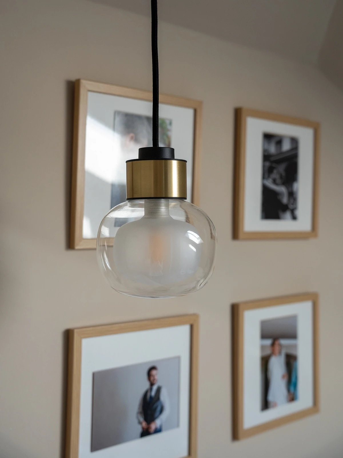 Lampada a sospensione in vetro e metallo con luce diffusa in un ambiente residenziale progettato a Torino