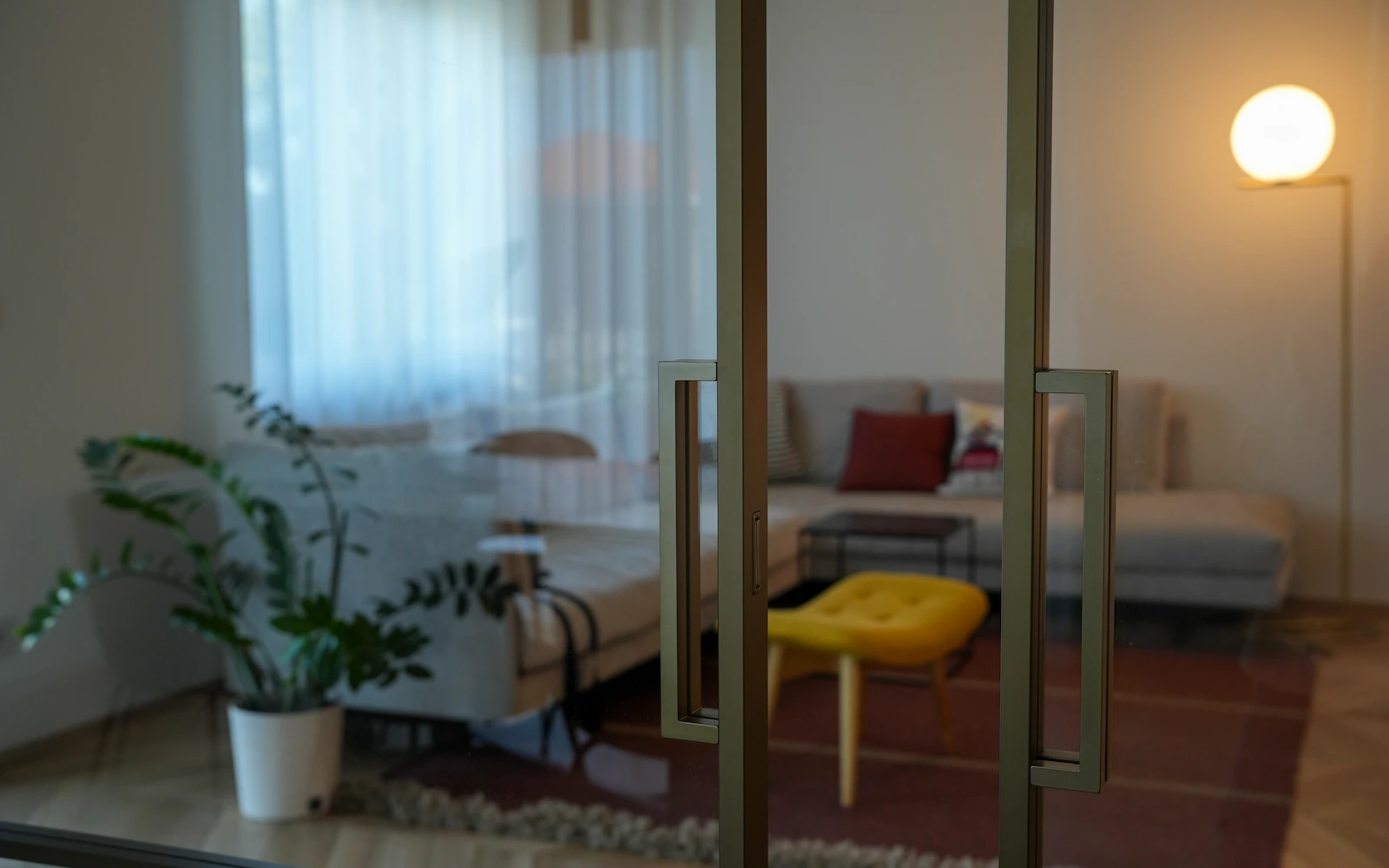 Vetrata interna con vista sul soggiorno che valorizza la continuit&agrave; degli spazi in un appartamento ristrutturato a Torino
